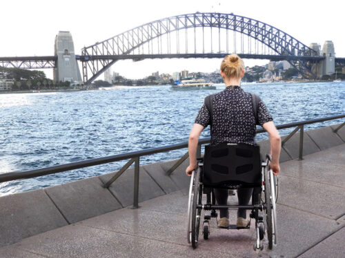 wheelchair traveller at sydney opera house and harbour bridge